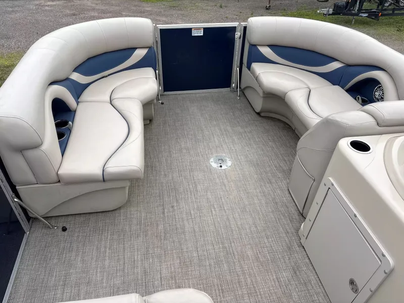 Slide: The Image of Interior of a Sylvan MIR 8520 CNF pontoon boat with beige and blue seating. - 2