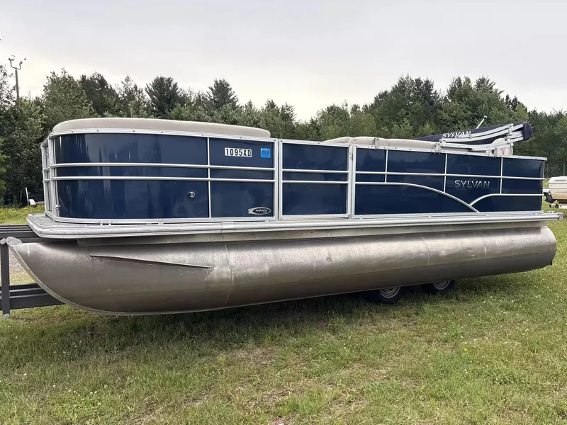 The Image of 2016 Sylvan MIR 8520 CNF pontoon boat on grass with forest in the background. - 1