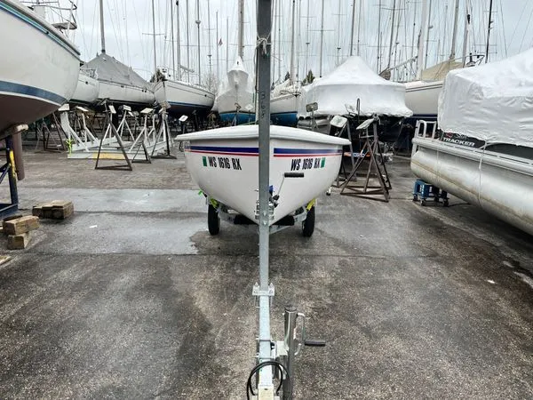 Slide: The Image of A Catalina Expo 14.2 boat is on a trailer in a marina area. - 5