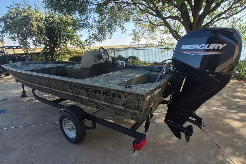 Slide: The Image of 2026 Tracker Grizzly 1648 SC boat with Mercury outboard motor on trailer. - 7