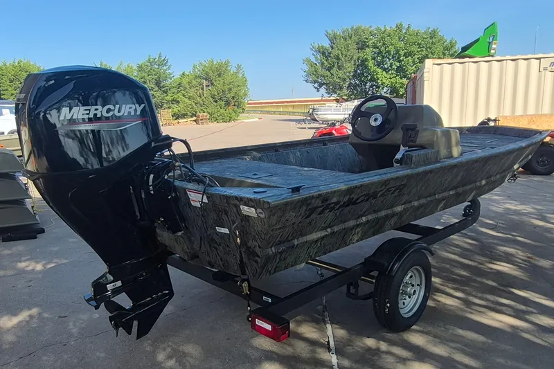 Slide: The Image of 2026 Tracker Grizzly 1648 SC boat with Mercury engine on trailer, outdoors. - 5