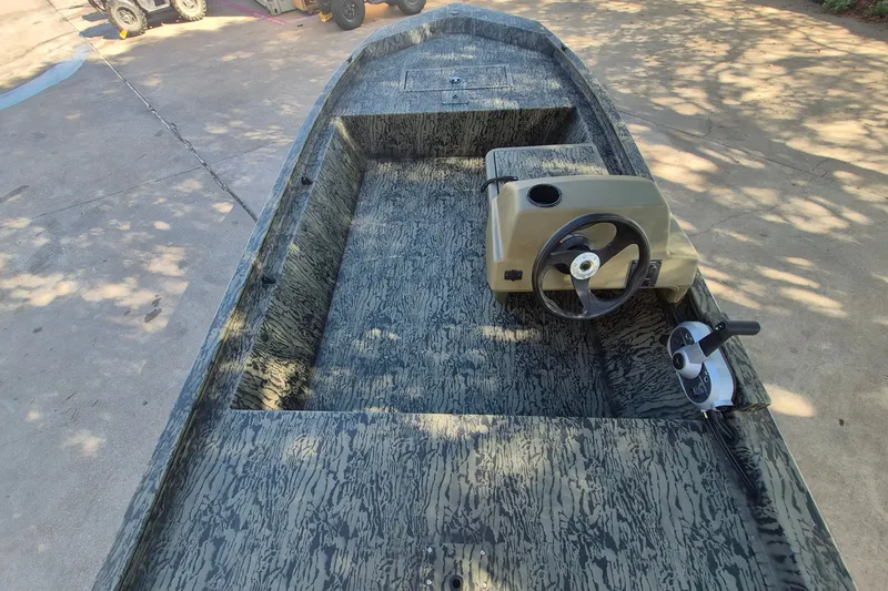 Slide: The Image of 2026 Tracker Grizzly 1648 SC boat with camouflage interior and steering console. - 9