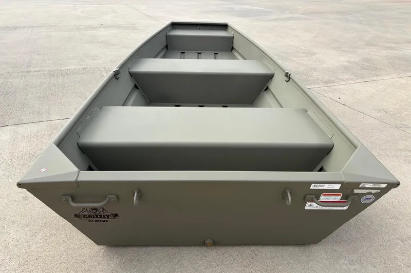 Slide: The Image of 2026 Tracker Grizzly 12 Jon boat, olive green, on concrete surface. - 3