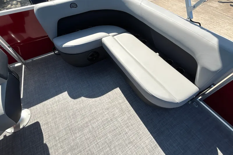 Slide: The Image of 2026 Sun Tracker Party Barge 16 DLX interior with gray seating and cup holders. - 15