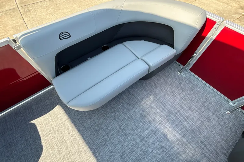 Slide: The Image of 2026 Sun Tracker Party Barge 16 DLX interior with gray seating and red paneling. - 16