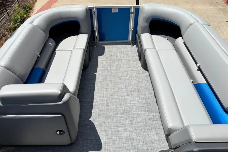 Slide: The Image of 2026 Sun Tracker Party Barge 20 DLX with spacious gray seating and blue accents. - 3