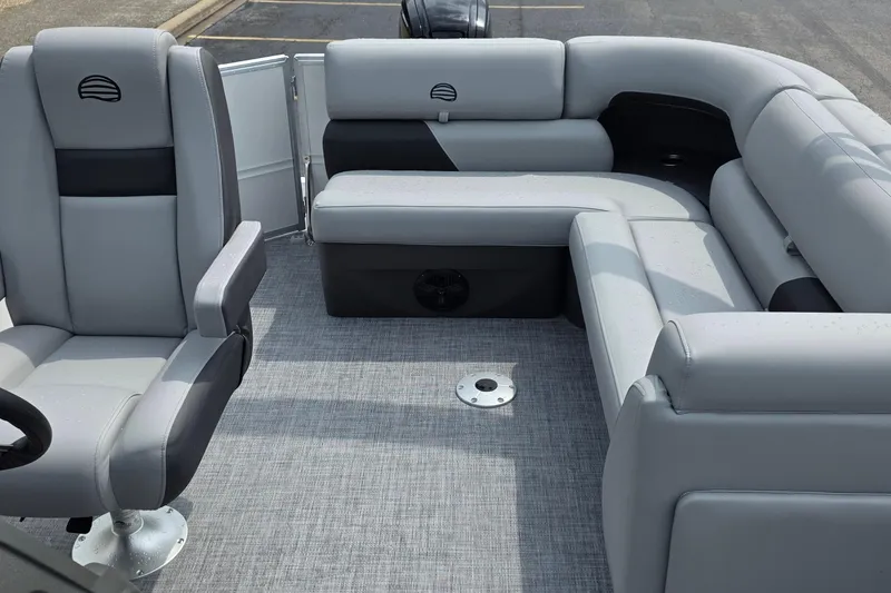 Slide: The Image of 2026 Sun Tracker Party Barge 20 DLX interior with gray seating and carpeted floor. - 11