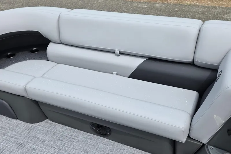Slide: The Image of 2026 Sun Tracker Party Barge 20 DLX seating area with gray upholstery and cup holders. - 13