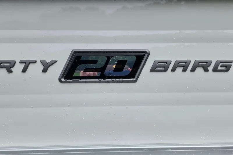 Slide: The Image of Sun Tracker Party Barge 20 DLX 2026 logo on a wet surface. - 16