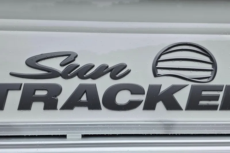Slide: The Image of Sun Tracker logo on 2026 Party Barge 20 DLX boat exterior. - 17