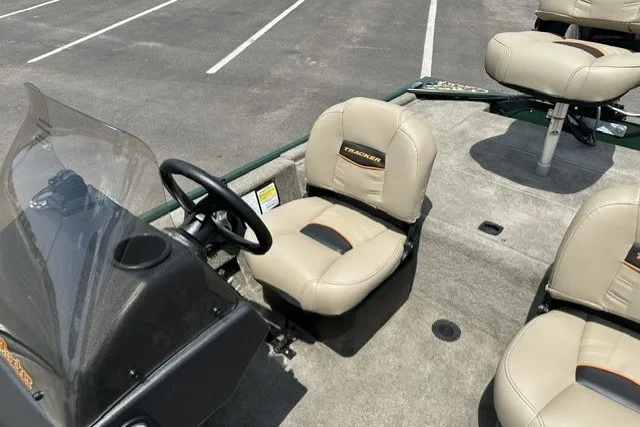Slide: The Image of 2026 Tracker Bass Tracker Classic Limited boat with beige seating in a parking lot. - 15