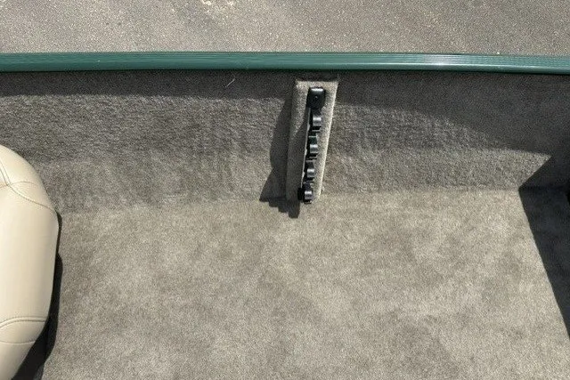 Slide: The Image of Interior view of a boat with gray carpeting and a switch panel. - 18