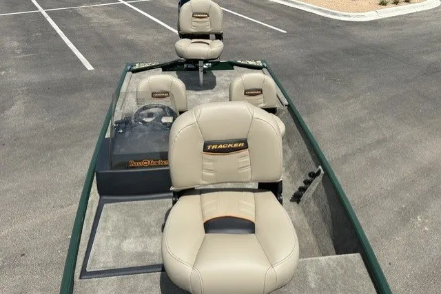 Slide: The Image of 2026 Tracker Bass Tracker Classic Limited boat with beige seats in a parking lot. - 13