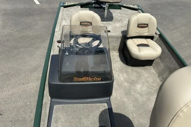 Slide: The Image of 2026 Tracker Bass Tracker Classic Limited boat interior with beige seats and steering console. - 14