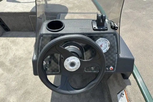Slide: The Image of Steering console of 2026 Tracker Bass Tracker Classic Limited boat with gauge and cup holder. - 16