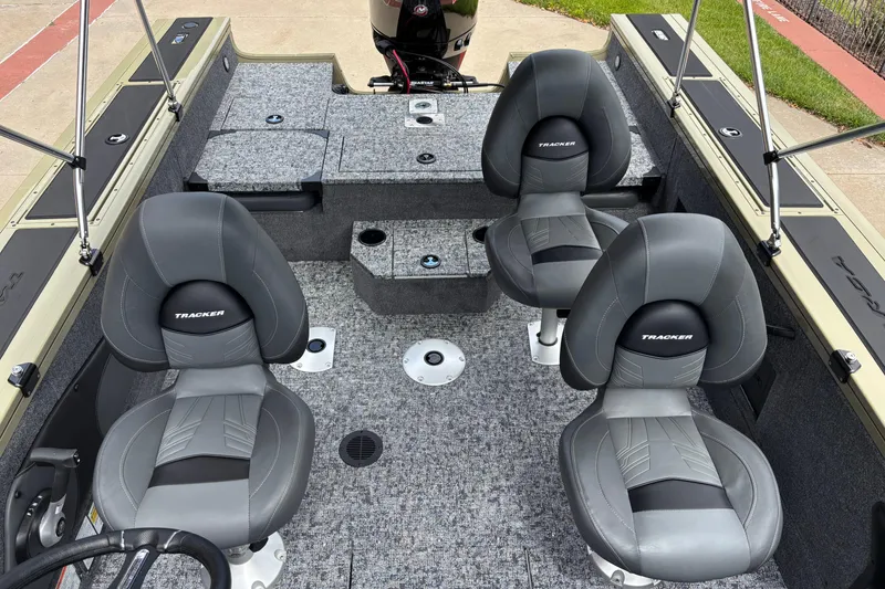 Slide: The Image of 2026 Tracker Targa V-18 Combo boat interior with four gray seats and carpeted flooring. - 4