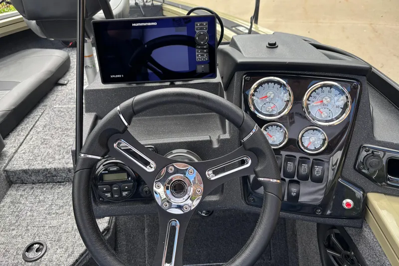 Slide: The Image of 2026 Tracker Targa V-18 Combo dashboard with steering wheel, gauges, and Humminbird Xplore 9 display. - 7