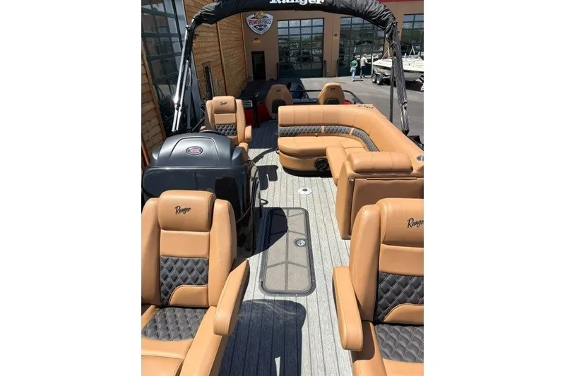 Slide: The Image of 2026 Ranger 223F boat interior with tan leather seating and modern design. - 2