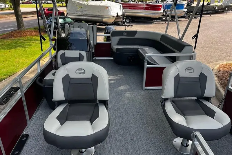 Slide: The Image of 2026 Sun Tracker Bass Buggy 16 XL Select pontoon boat interior with seating and steering console. - 2