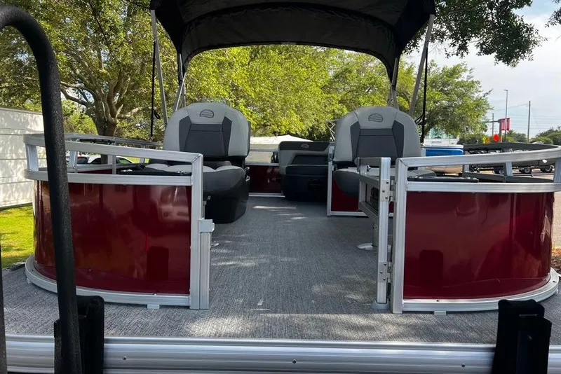Slide: The Image of 2026 Sun Tracker Bass Buggy 16 XL Select pontoon boat with seating, under a canopy. - 3