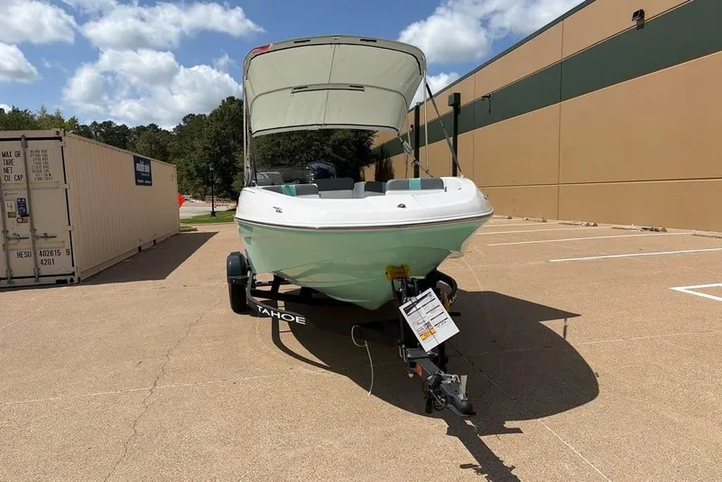 Slide: The Image of 2026 Tahoe T16 boat on trailer, parked outdoors under a clear sky. - 3