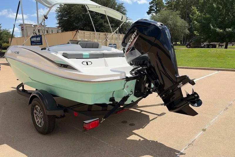 Slide: The Image of 2026 Tahoe T16 boat with Mercury outboard motor on a trailer in a sunny setting. - 5