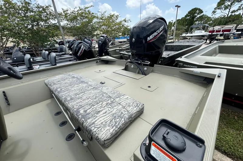 Slide: The Image of 2026 Tracker Grizzly 2072 CC boat with Mercury engine, camo seating, and spacious deck. - 5