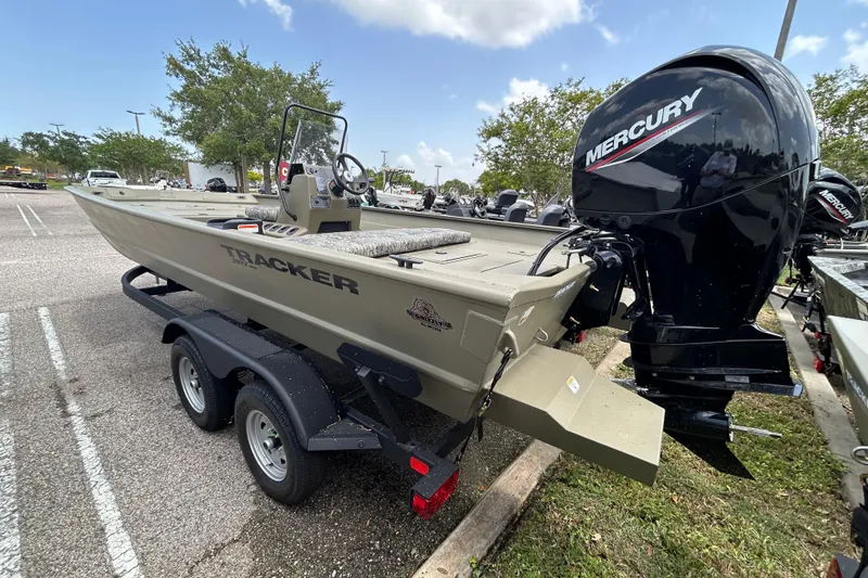 Slide: The Image of 2026 Tracker Grizzly 2072 CC boat with Mercury engine on trailer in parking lot. - 2