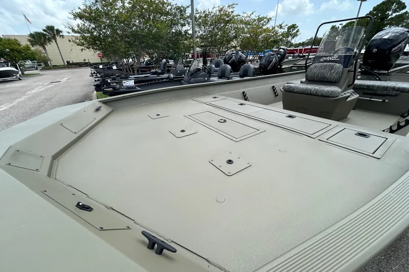 Slide: The Image of 2026 Tracker Grizzly 2072 CC boat with spacious deck and seating in a parking lot. - 3