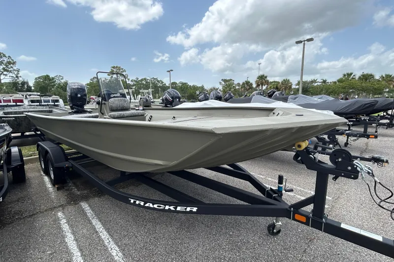 The Image of 2026 Tracker Grizzly 2072 CC boat on trailer in parking lot under cloudy sky. - 0