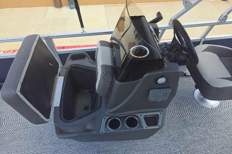 Slide: The Image of 2026 Sun Tracker Bass Buggy 18 DLX boat interior with steering console and seating. - 13