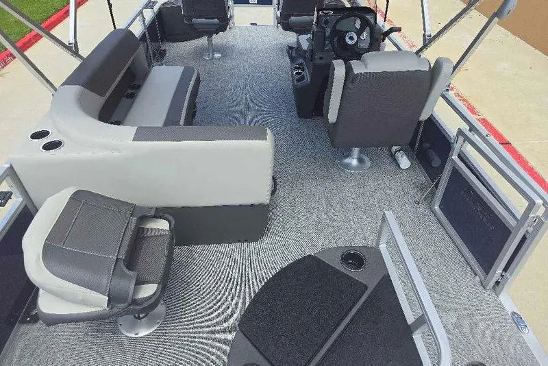 Slide: The Image of 2026 Sun Tracker Bass Buggy 18 DLX interior with seating and steering console. - 5
