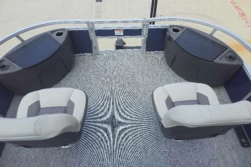 Slide: The Image of 2026 Sun Tracker Bass Buggy 18 DLX pontoon boat interior with seating and cup holders. - 4