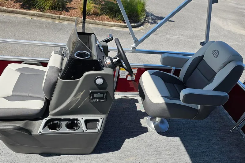 Slide: The Image of Interior of 2026 Sun Tracker Bass Buggy 16 XL Select pontoon boat with steering console and seating. - 5