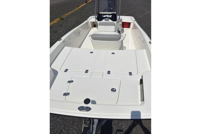 Slide: The Image of 2026 Mako Pro Skiff 15 CC boat interior with seating and storage compartments. - 8