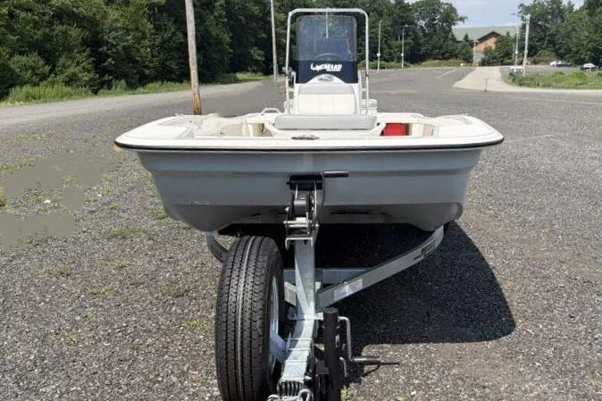 Slide: The Image of 2026 Mako Pro Skiff 15 CC boat on trailer in parking lot. - 6
