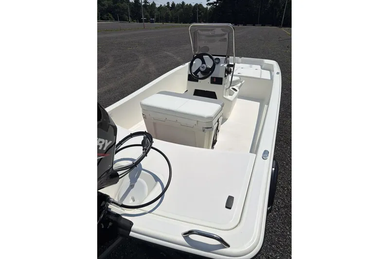 Slide: The Image of 2026 Mako Pro Skiff 15 CC boat with center console and outboard motor. - 9