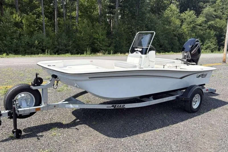The Image of 2026 Mako Pro Skiff 15 CC boat on trailer, parked outdoors. - 0