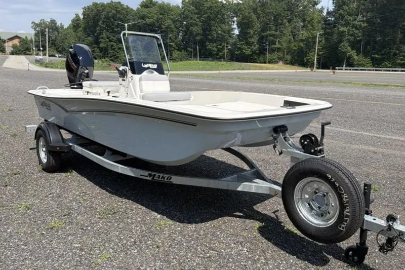 Slide: The Image of 2026 Mako Pro Skiff 15 CC boat on trailer, parked outdoors. - 2