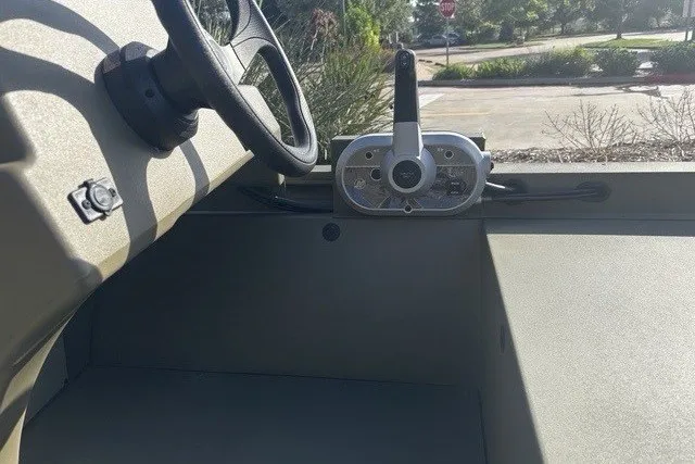 Slide: The Image of Interior view of 2026 Tracker Grizzly 1648 SC boat showing steering wheel and control panel. - 5