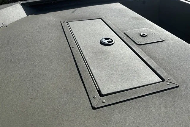 Slide: The Image of 2026 Tracker Grizzly 1648 SC boat deck with storage compartment and latch. - 10