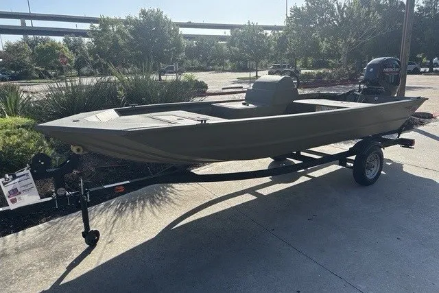 The Image of 2026 Tracker Grizzly 1648 SC boat on trailer, parked outdoors in sunny setting. - 0