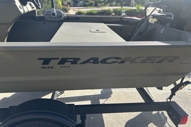 Slide: The Image of 2026 Tracker Grizzly 1648 SC boat on trailer, side view in sunlight. - 9