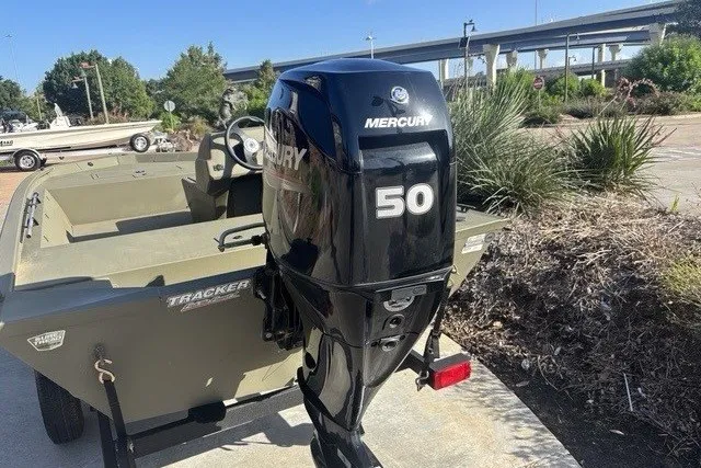 Slide: The Image of 2026 Tracker Grizzly 1648 SC boat with Mercury 50 outboard motor in outdoor setting. - 12