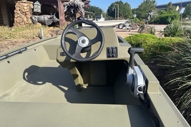 Slide: The Image of 2026 Tracker Grizzly 1648 SC boat interior with steering wheel and control panel. - 4
