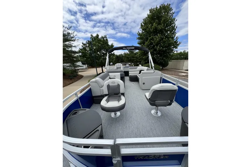 Slide: The Image of 2026 Sun Tracker Fishin' Barge 20 DLX pontoon boat with spacious seating and canopy. - 2