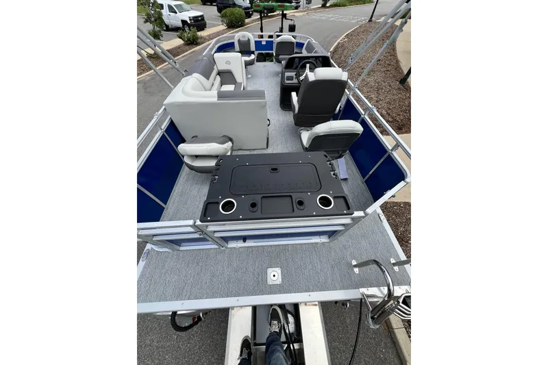 Slide: The Image of 2026 Sun Tracker Fishin' Barge 20 DLX pontoon boat interior with seating and fishing station. - 4