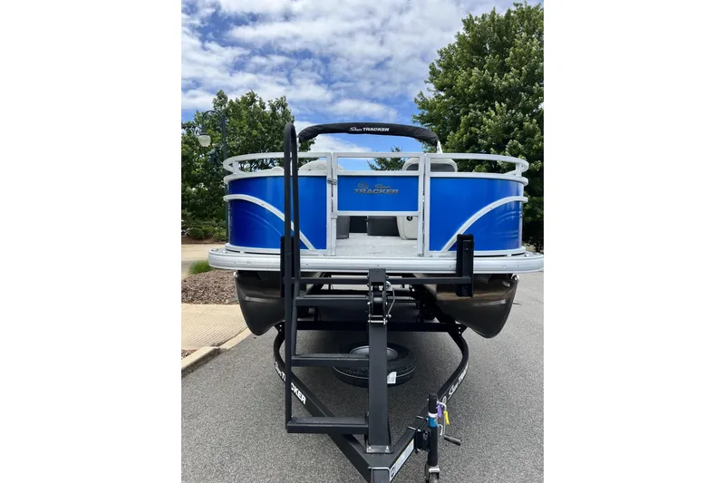 Slide: The Image of 2026 Sun Tracker Fishin' Barge 20 DLX pontoon boat on trailer, parked outdoors. - 5