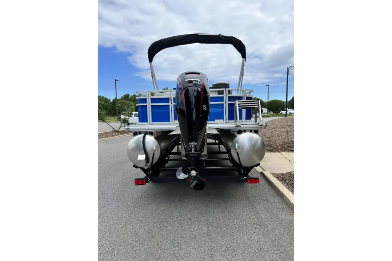 Slide: The Image of 2026 Sun Tracker Fishin' Barge 20 DLX pontoon boat, rear view with outboard motor. - 6