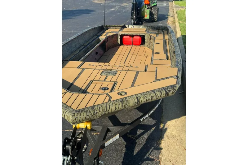 Slide: The Image of 2026 Tracker Grizzly 1756 T Marsh boat on trailer, featuring camo design and spacious deck. - 3